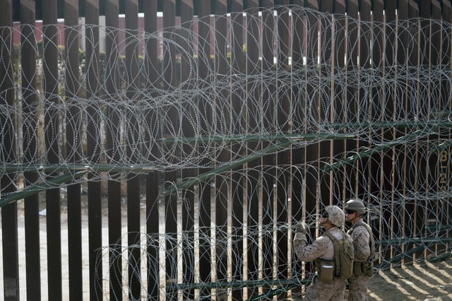 U.S. Marines install barbed wire along the border fence Friday, Jan. 31, 2025, in San Diego. (AP Photo/Jae C. Hong)