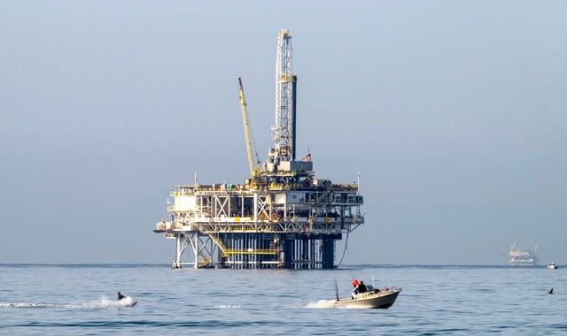 A boat pulls a wake boarder past an oil rig just off the coast of Huntington Dog Beach in Huntington Beach on Saturday morning, March 9, 2024. (Photo by Mark Rightmire, Orange County Register/SCNG)