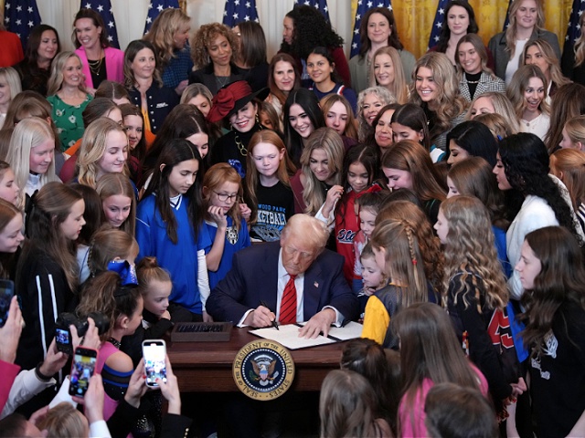 WASHINGTON, DC - FEBRUARY 05: U.S. President Donald Trump joined by women athletes signs the “No Men in Women’s Sports” executive order in the East Room at the White House on February 5, 2025 in Washington, DC. The executive order, which Trump signed on National Girls and Women in Sports Day, prohibits transgender women from competing in women’s sports and is the third order he has signed that targets transgender people. (Photo by Andrew Harnik/Getty Images)