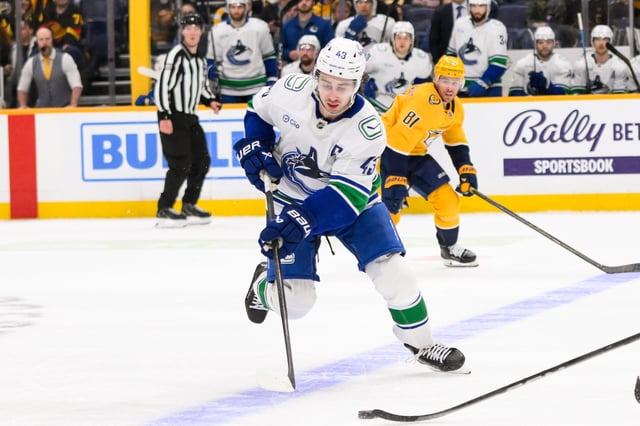Jan 29, 2025; Nashville, Tennessee, USA;  Vancouver Canucks defenseman Quinn Hughes (43) skates with the puck against the Nashville Predators during the second period at Bridgestone Arena. Mandatory Credit: Steve Roberts-Imagn Images/File Photo