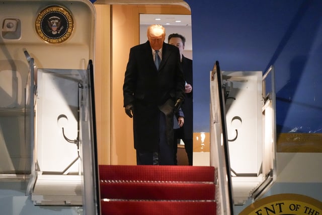President Donald Trump, followed by Elon Musk arrives on Air Force One, Wednesday, Feb. 19, 2025, at Joint Base Andrews, Md, after returning from Florida. (AP Photo/Mark Schiefelbein)