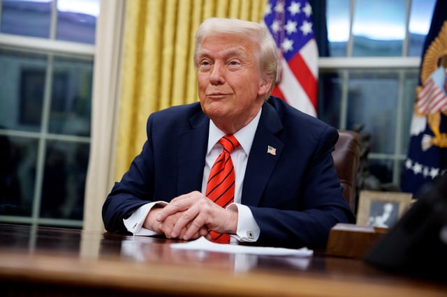 President Donald Trump reacts to a question from a reporter after signing a series of executive orders in the Oval Office at the White House on February 10, 2025 in Washington, DC.