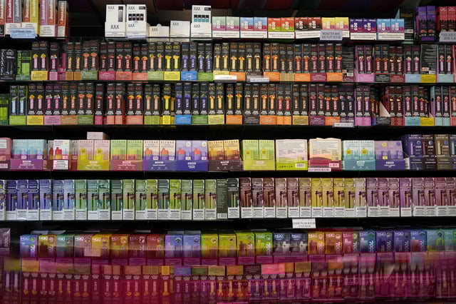 FILE - Disposable flavored electronic cigarette devices are displayed for sale at a store in Pinecrest, Fla., Monday, June 26, 2023. (AP Photo/Rebecca Blackwell, File)