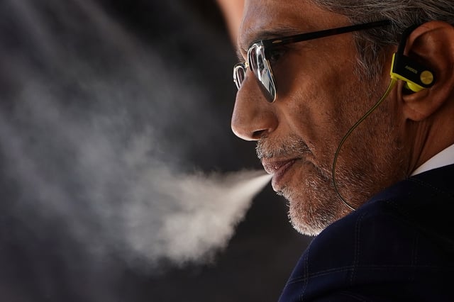 A man uses a vaping product in the Manhattan borough of New York, New York, U.S., September 17, 2019. REUTERS/Carlo Allegri/File Photo