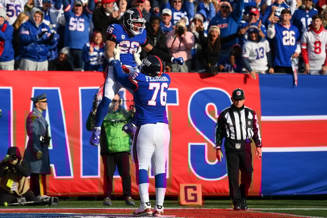 Dec 4, 2022; East Rutherford, New Jersey, USA; New York Giants running back Saquon Barkley (26) celebrates his touchdown with guard Jon Feliciano (76) against the Washington Commanders during the first half at MetLife Stadium. Mandatory Credit: Rich Barnes-USA TODAY Sports/File Photo