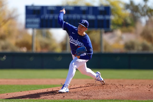 GLENDALE, ARIZONA - FEBRUARY 15: Bobby Miller #28 of the Los Angeles Dodgers participates in a throwing session during spring training workouts at Camelback Ranch on February 15, 2025 in Glendale, Arizona.