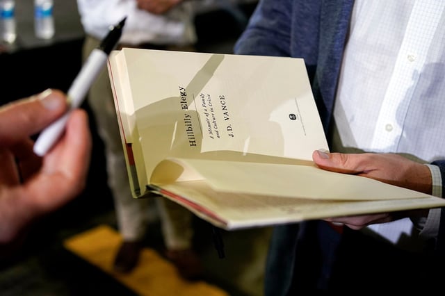 JD Vance autographs his book after a rally in Middletown, Ohio, in July 2021.