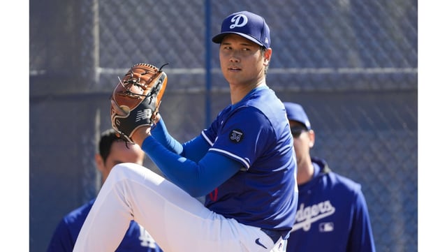 Dodgers star Shohei Ohtani throws to the plate during a bullpen session on Tuesday in Glendale, Arizona. Ohtani, who is not expected to pitch in a major-league game until May, says he is exploring options with his pitching mechanics. (AP Photo/Ashley Landis)