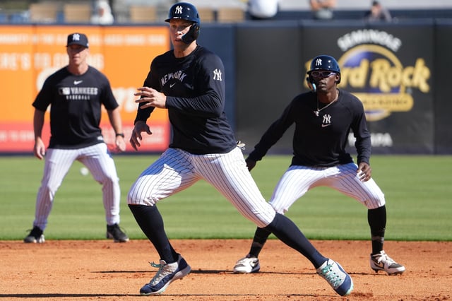 Feb 17, 2025; Tampa, FL, USA; New York Yankees outfielder Aaron Judge (99) (center) and third base Jazz Chisholm Jr. (13) (right) participate in a base running drill during spring training practice at George M. Steinbrenner Field.