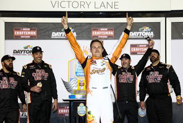 Parker Kligerman, driver of the #75 Spiked Coolers Chevrolet celebrates in victory lane after winning the NASCAR Craftsman Truck Series Fresh from Florida 250 at Daytona International Speedway on February 14, 2025 in Daytona Beach, Florida.