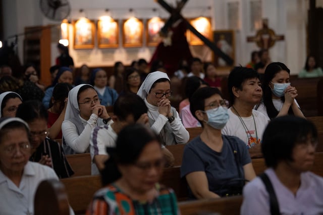 Catholics pray for Pope Francis at a church in Manila, Philippines on Thursday. Worshipers have congregated across the world to offer devotion for the 88-year-old pontiff's recovery.