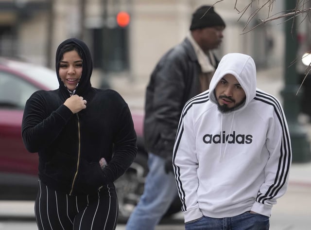 Pedestrians walk in downtown as Houston endures its latest round of bitterly cold temperatures on Thursday. Spring is nearly here and NOAA forecasters are very confident it will be warmer but also drier than normal.