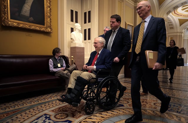 WASHINGTON, DC - FEBRUARY 20: Sen. Mitch McConnell (R-KY) is pushed in a wheelchair at the U.S. Capitol on February 20, 2025 in Washington, DC.