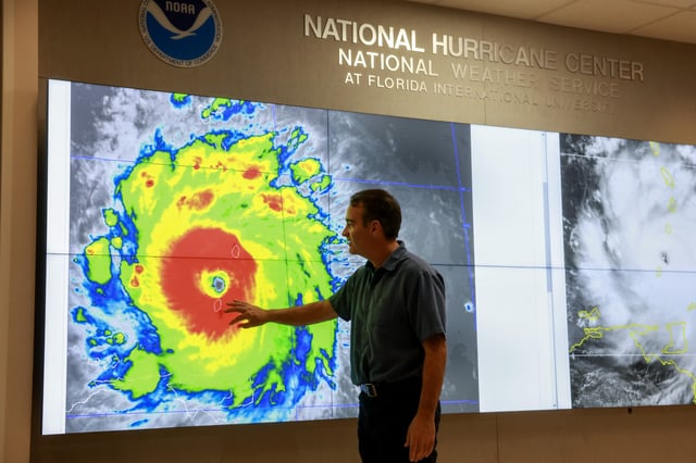 A specialist tracking a storm at the National Hurricane Center, one of the services provided by the National Oceanic and Atmospheric Administration, which faces mass job cuts.