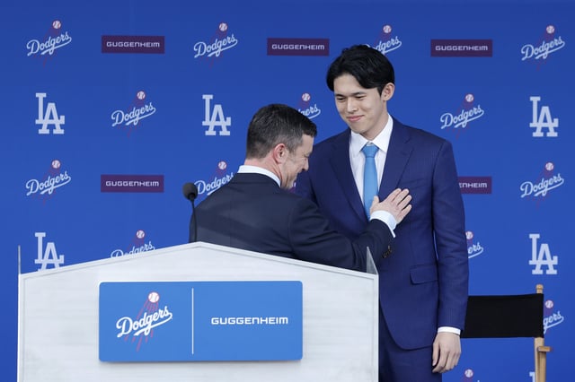 President, Baseball Operations Andrew Friedman and Pitcher Roki Sasaki talk during a Los Angeles Dodgers press conference at Dodger Stadium on January 22, 2025 in Los Angeles, California.