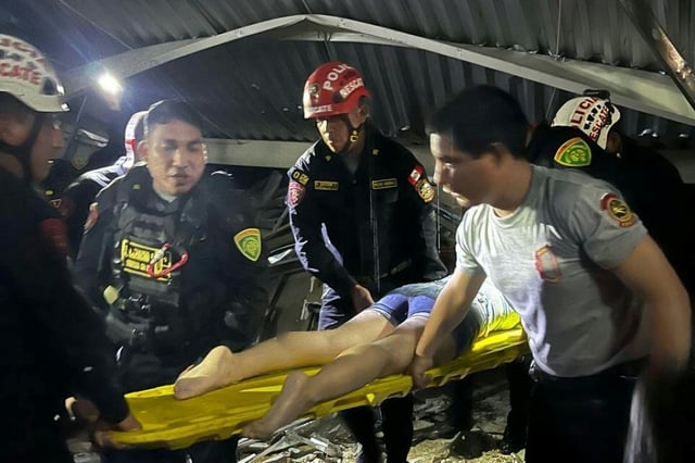 Rescue teams working at the scene where the roof of a food court in a shopping center collapsed in Trujillo, Peru