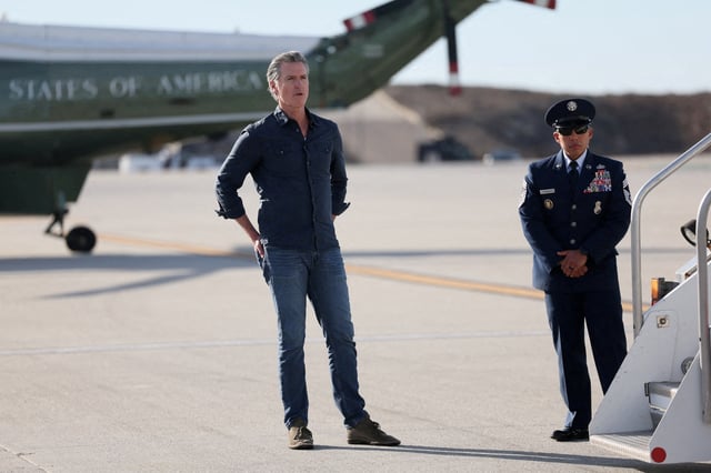 Governor of California Gavin Newsom waits for U.S. President Donald Trump, who arrives to tour areas impacted or destroyed by the southern California wildfires, at Los Angeles International Airport in Los Angeles, California, U.S., January 24, 2025. REUTERS/Leah Millis/File Photo