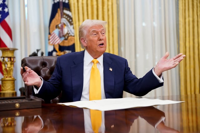 U.S. President Donald Trump sits in the Oval Office of the White House, on the day Howard Lutnick is sworn in as U.S. Commerce Secretary by Vice President JD Vance, in Washington, DC, U.S., February 21, 2025.