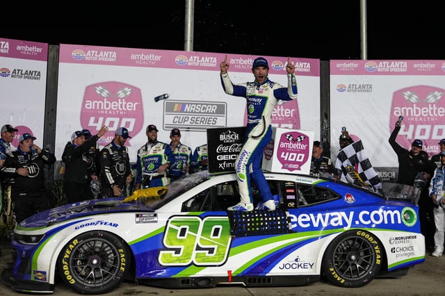 NASCAR Cup Series driver Daniel Suarez (99) celebrates in Victory Lane after winning the Ambetter Health 400 at Atlanta Motor Speedway.