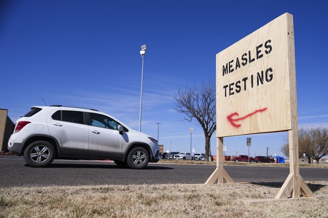 A vehicle drives past a sign outside of Seminole Hospital District offering measles testing Friday, Feb. 21, 2025, in Seminole, Texas.