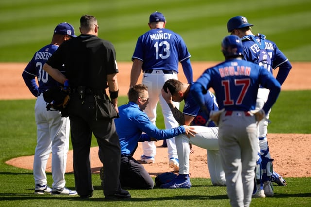 Dodgers pitcher Bobby Miller reacts after being hit by a line drive from the Cubs’ Michael Busch during the third inning of a spring training game, Thursday, Feb. 20, 2025, in Phoenix. (AP Photo/Ashley Landis)
