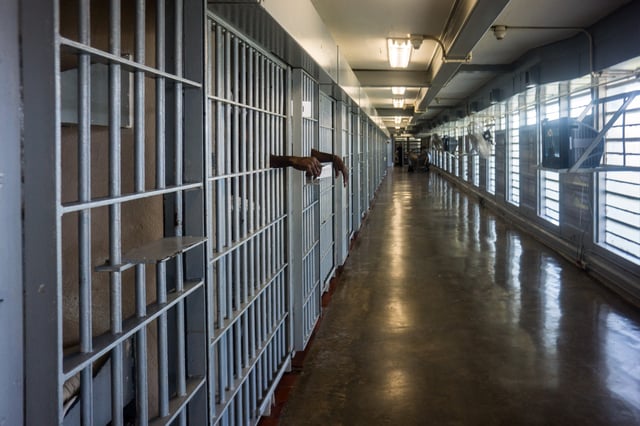 A prisoner's hands inside a punishment cell wing at Angola prison on Oct. 14, 2013. The Louisiana State Penitentiary, also known as Angola, and nicknamed the "Alcatraz of the South" and "The Farm" is a maximum-security prison farm in Louisiana operated by the Louisiana Department of Public Safety & Corrections. It is named Angola after the former plantation that occupied this territory, which was named for the African country that was the origin of many enslaved Africans brought to Louisiana in slavery times.