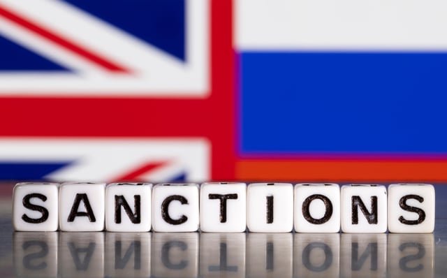 Plastic letters arranged to read "Sanctions" are placed in front the Union Jack and Russian flag colors in this illustration taken February 28, 2022. REUTERS/Dado Ruvic/Illustration/File Photo