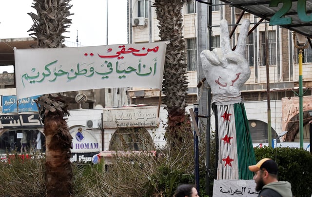 A banner reading "I have the right to live in a free and dignified homeland" is put up at Al-Karama Square in Sweida, Syria February 20, 2025. REUTERS/Yamam Al Shaar