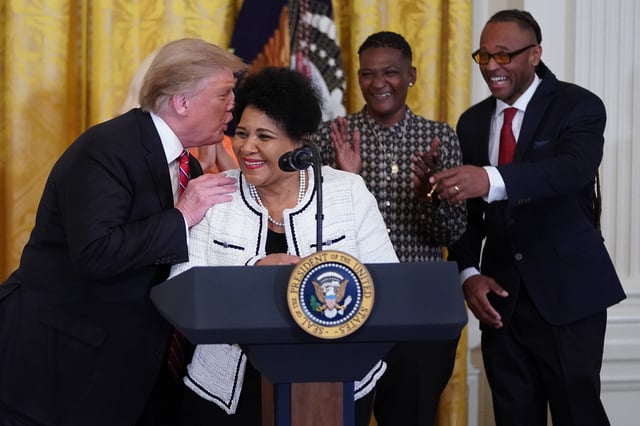 President Donald Trump speaks to Alice Marie Johnson in the East Room of the White House April 1, 2019 in Washington, DC. Trump has named Johnson his new &#34;pardon czar.&#34;