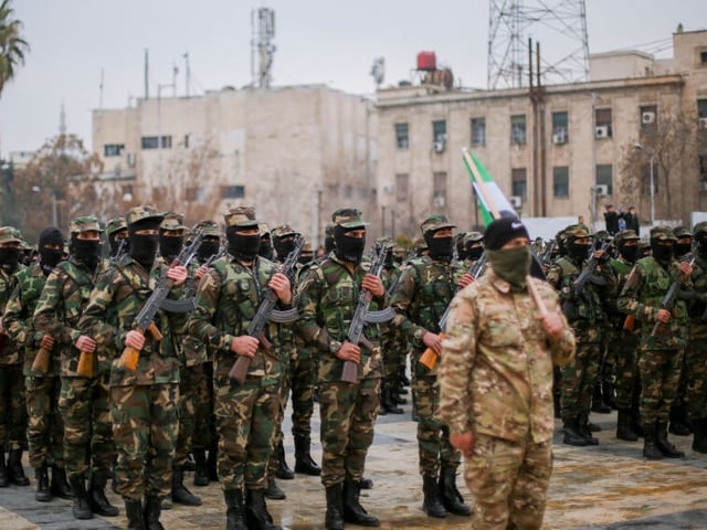Graduates of Syria's General Security forces under the country's new administration attend a ceremony in the northern city of Aleppo on February 12, 2025. Syrian interim President Ahmed al-Sharaa said in an interview released on February 10, that "thousands" of people were joining the country's new army following the overthrow of Bashar al-Assad and the dissolution of his military. Since the fall of longtime ruler Assad in December, Syria's authorities have dissolved the former military and security services, and have set up centers for personnel who served under the ousted government to settle their status. (Photo by Asaad Al Asaad / Middle East Images / Middle East Images via AFP) (Photo by ASAAD AL ASAAD/Middle East Images/AFP via Getty Images)