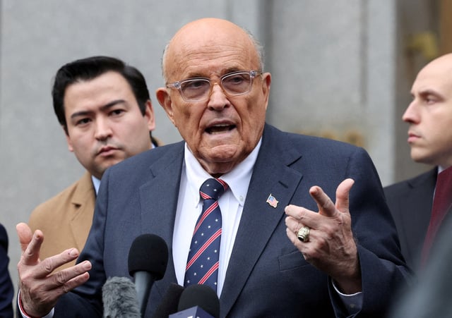 Former Donald Trump lawyer and former New York City Mayor Rudolph Giuliani speaks to the media as he departs the U.S. Federal court following a hearing in his case to surrender valuables to Georgia election workers he was found to have defamed, in New York City, U.S., November 26, 2024. REUTERS/Brendan McDermid/File Photo