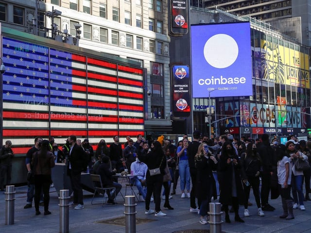 Coinbase Global watch as their listing is displayed on the Nasdaq MarketSite at Times Square in New York on April 14, 2021.