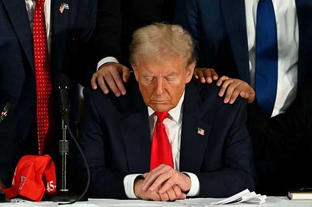 President Donald Trump, photographed praying with Latino community leaders in Miami in October 2024, had his effort to allow federal immigration authorities into religious spaces stalled by a preliminary injunction out of Maryland on Monday, Feb. 24, 2025.