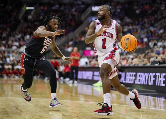 Jamal Shead #1 of the Houston Cougars goes to the basket against Joe Toussaint #6 of the Texas Tech Red Raiders during the first half of a semifinal game of the Big 12 Men&#39;s Basketball Tournament at T-Mobile Center on March 15, 2024 in Kansas City, Missouri.