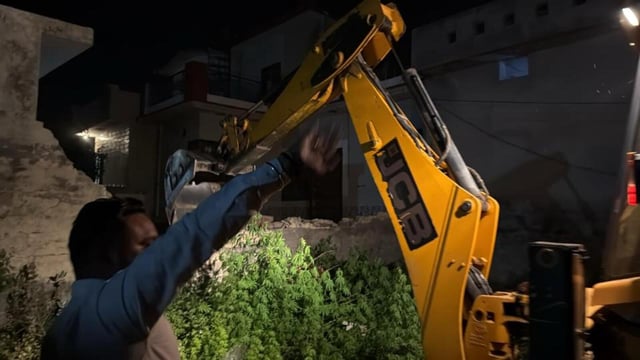 Punjab Police demolishing the house of a drug smuggler at Talwandi village near Ladhowal in Ludhiana district on Monday night. (HT Photo)