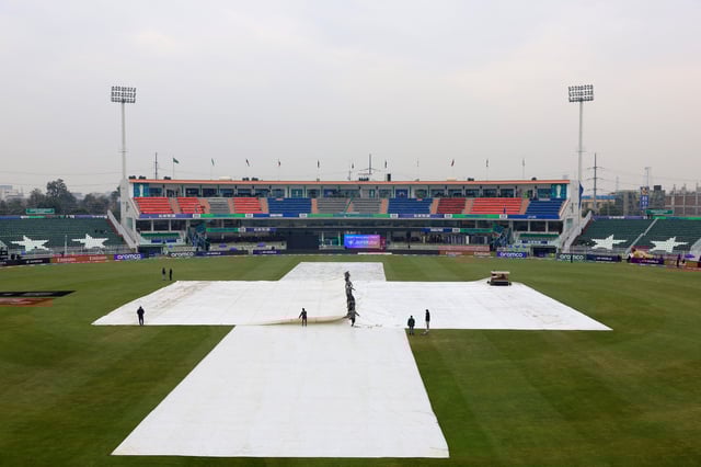 Cricket - ICC Men's Champions Trophy - Group B - Australia v South Africa - Rawalpindi Cricket Stadium, Rawalpindi, Pakistan - February 25, 2025 Groundstaff pull rain covers on the pitch before the match REUTERS/Akhtar Soomro