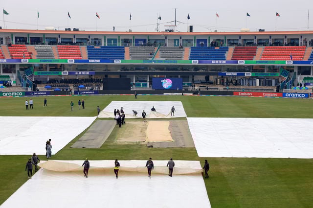 Cricket - ICC Men's Champions Trophy - Group B - Australia v South Africa - Rawalpindi Cricket Stadium, Rawalpindi, Pakistan - February 25, 2025 Groundstaff pull rain covers on the pitch before the match REUTERS/Akhtar Soomro