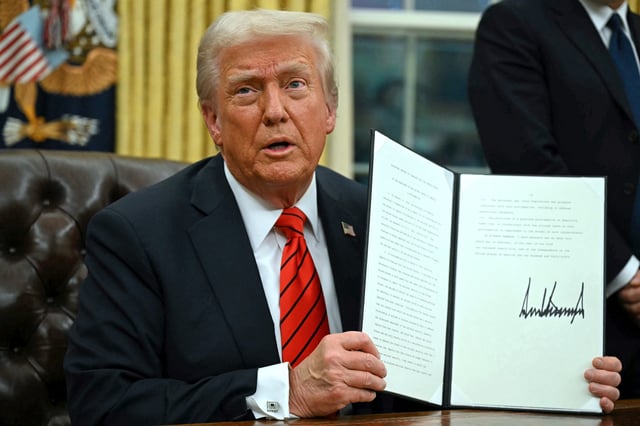 President Donald Trump signs an executive order in the Oval Office of the White House on Feb. 10, in Washington, DC.
