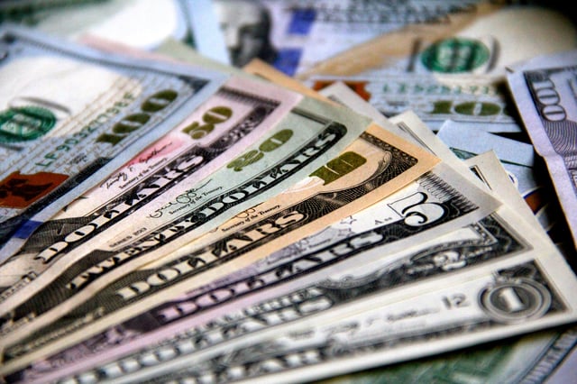 Stock image/file photo: U.S. Dollars laid out on a surface.