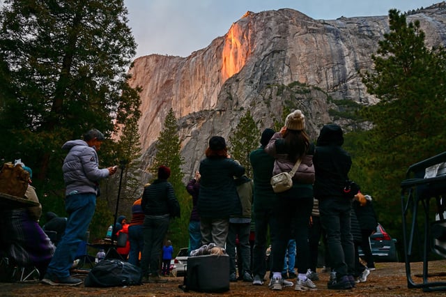 A view of Firefall effect on El Capitan during sunset at Horsetail Fall as hundreds of tourists and photographers flock in Yosemite National Park, California, United States on February 19, 2025. 