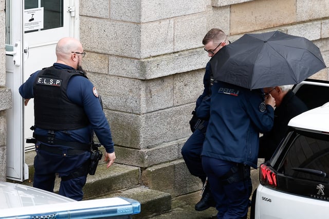 Prison officers escort ex-surgeon Joel Le Scouarnec from a vehicle, during his trial, where he is charged with aggravated rape and sexual assault against hundreds of children over several decades, in Vannes, Brittany, France, February 25, 2025. REUTERS/Stephane Mahe