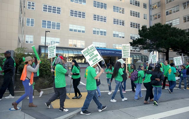 Health care workers at UCSF Medical Center on Parnassus Ave. protest about pay issues, as seen in 2018. Two strikes are planned at UCSF later this week.