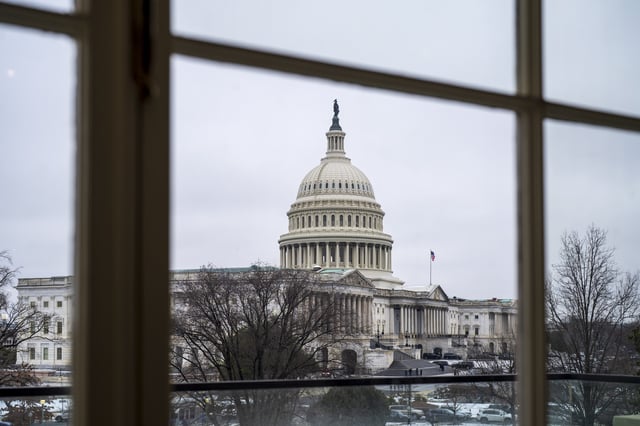 The Capitol is seen framed through a window in the Cannon House Office Building on Capitol Hill in Washington, Thursday, Feb. 13, 2025. (AP Photo/J. Scott Applewhite)