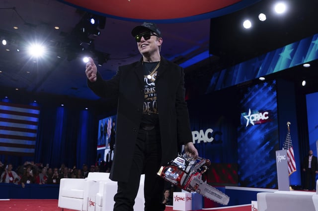 Elon Musk waves to the crowd as he holds a chainsaw after speaking at the Conservative Political Action Conference, CPAC, at the Gaylord National Resort & Convention Center, Thursday, Feb. 20, 2025, in Oxon Hill, Md. (AP Photo/Jose Luis Magana)