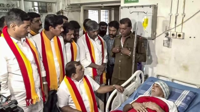 Pro-Kannada activist TA Narayana Gowda meets an injured person at a hospital following incidents of attacks on buses and their crew in Belagavi district onTuesday. (PTI)