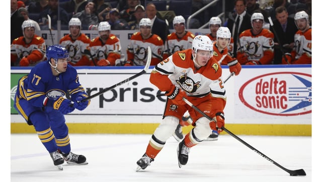 Ducks defenseman Jackson LaCombe is chased by Buffalo Sabres right wing JJ Peterka during the second period on Tuesday night in Buffalo, N.Y. The Ducks had a two-goal lead after two periods, but lost, 3-2. (AP Photo/Jeffrey T. Barnes)