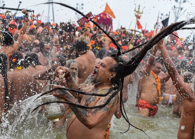 Naga Sadhus take a holy dip at Sangam, confluence of Ganges, Yamuna and mythological Saraswati rivers on the occasion of 'Makar Sankranti' the first royal bathing day of Kumbh Mela on January 14, 2025 in Allahabad, India. Kumbh Mela in 2025 is a Maha Kumbh, which is a significant Hindu festival celebrated once every 144 years at Prayagraj (Allahabad).