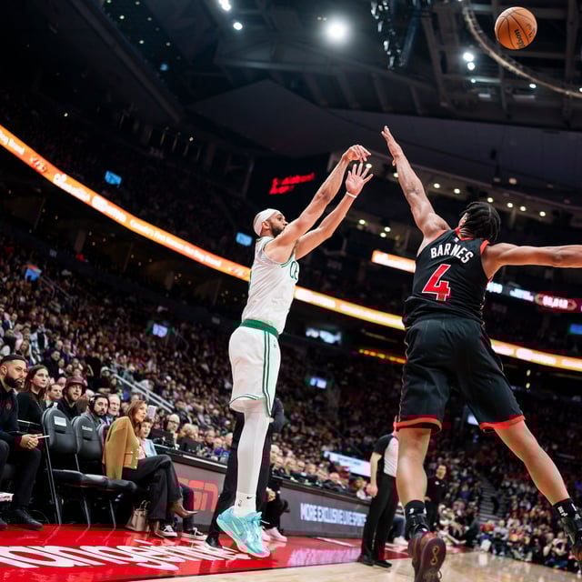 Boston Celtics guard Derrick White (9) shoots over Toronto Raptors forward Scottie Barnes (4) during the second half of NBA basketball action in Toronto on Tuesday, February 25, 2025. THE CANADIAN PRESS/Thomas Skrlj