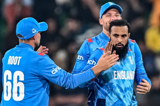 England&#39;s Adil Rashid (R) celebrates with teammates after taking the wicket of Australia&#39;s Marnus Labuschagne during the ICC Champions Trophy one-day international (ODI) cricket match between Australia and England at the Gaddafi Stadium in Lahore on February 22, 2025.