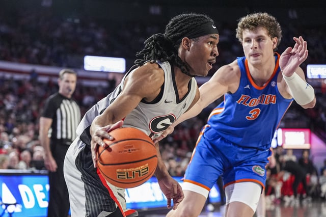 Feb 25, 2025; Athens, Georgia, USA; Georgia Bulldogs guard Silas Demary Jr. (5) dribbles against Florida Gators center Micah Handlogten (3) during the first half at Stegeman Coliseum. Mandatory Credit: Dale Zanine-Imagn Images